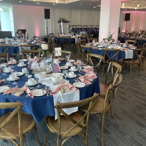 Versatile indoor banquet hall decorated for a memorable wedding or corporate event, featuring stylish table settings.